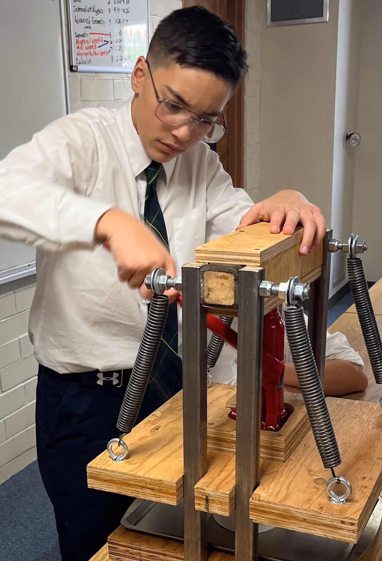 A Geneva Academy rhetoric-school student building a hydraulic press for a science project in Roseburg, Oregon