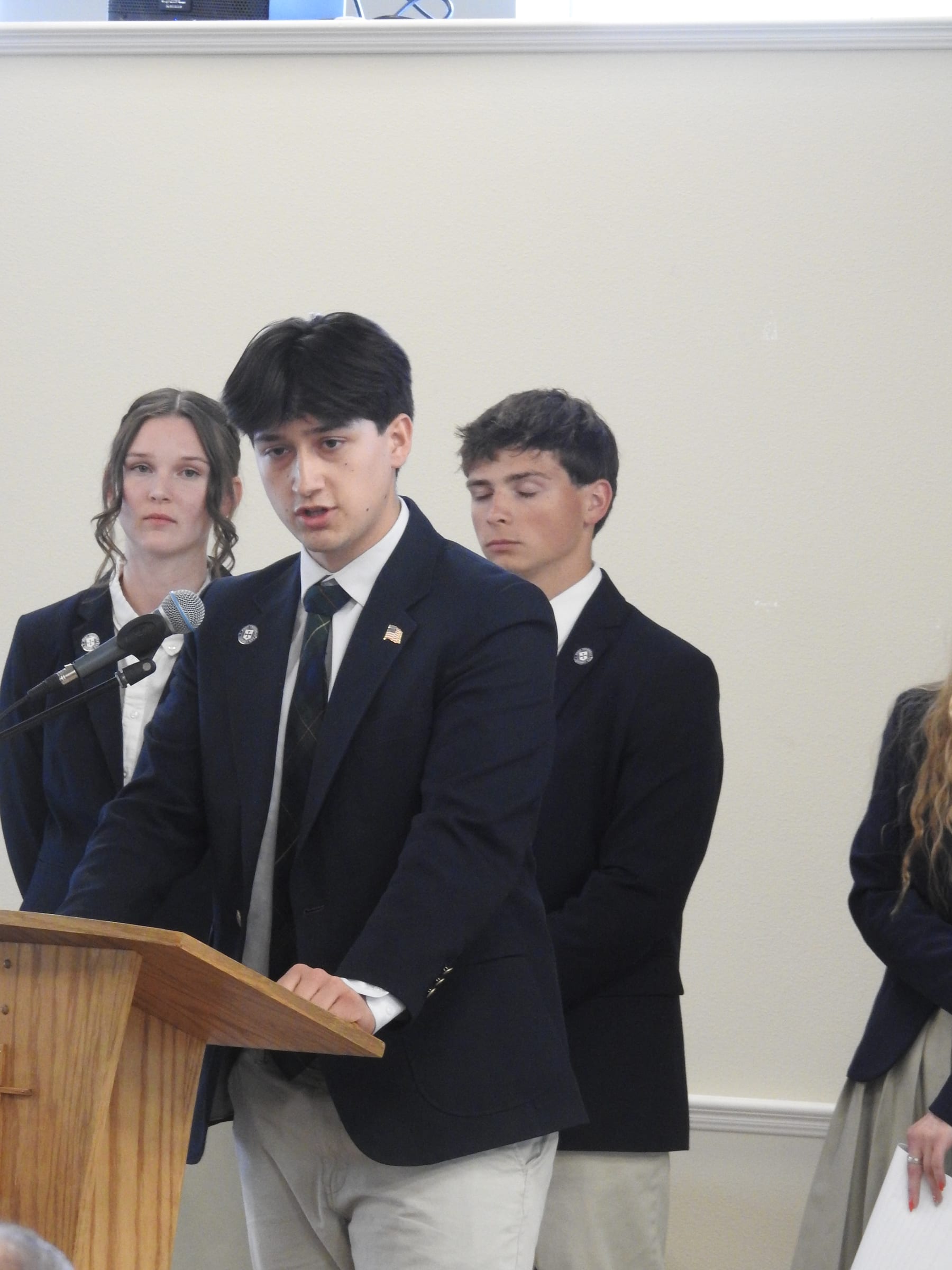 Geneva Academy rhetoric students presenting an argument at the microphone