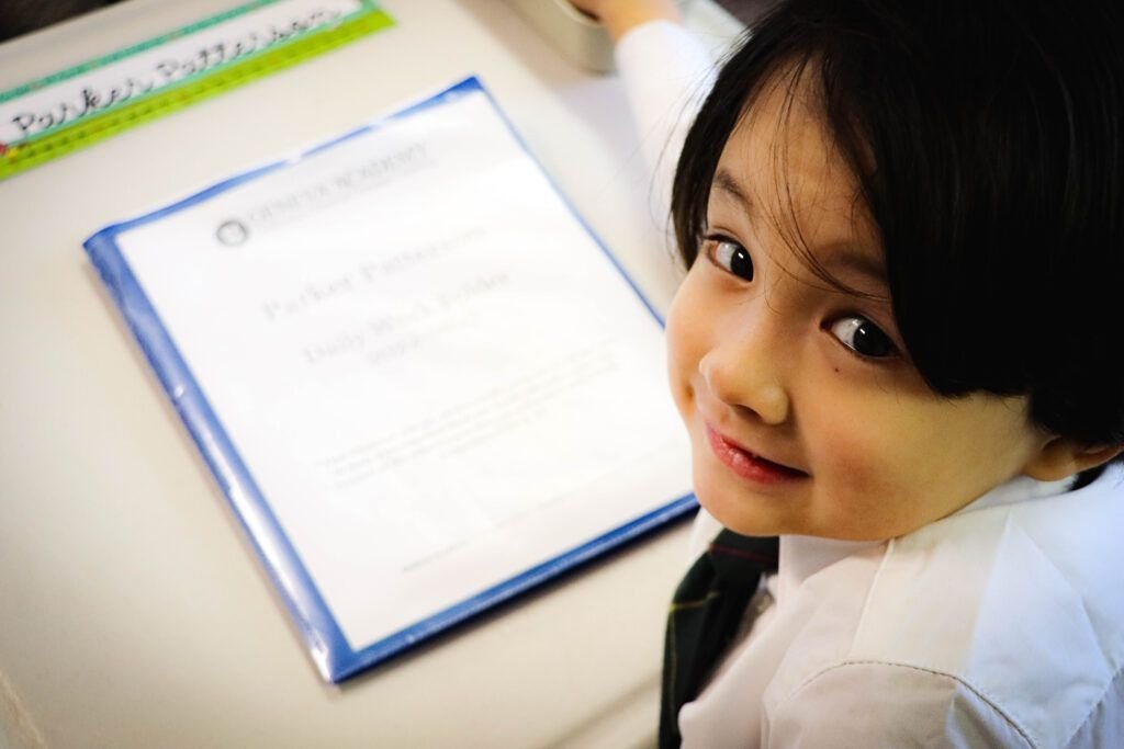 A kindergarten student with her daily work folder at Geneva Academy in Roseburg, Oregon